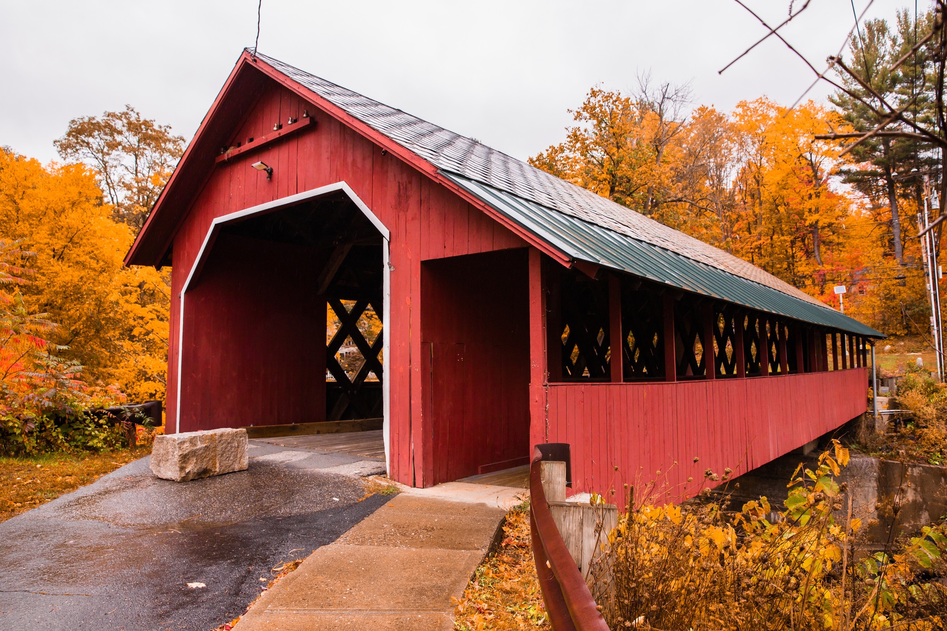 Beautiful Vermont covered bridge surrounded by colorful fall foliage.